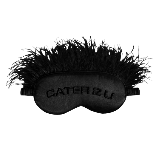 Beyoncé Cater 2 U black feather sleep mask front view featuring embroidered Cater 2 U lettering with glamorous feathered trim and satin texture