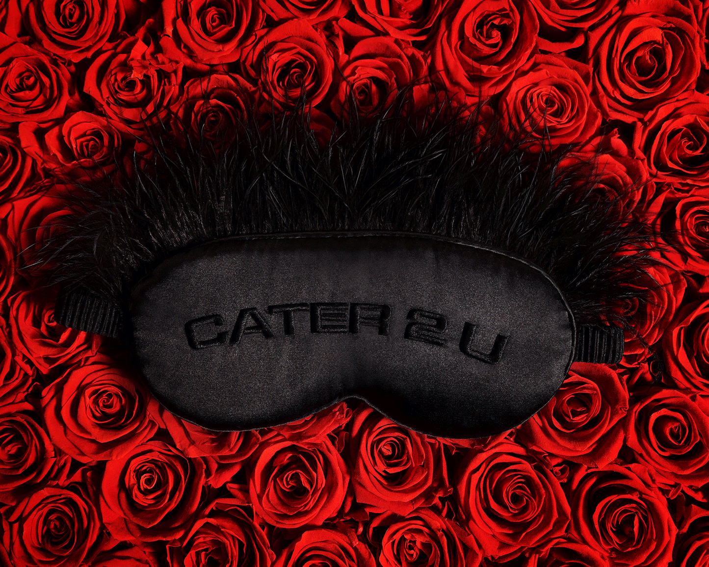 Beyoncé Cater 2 U black feather sleep mask displayed on red rose background featuring romantic luxury aesthetic and embroidered satin design