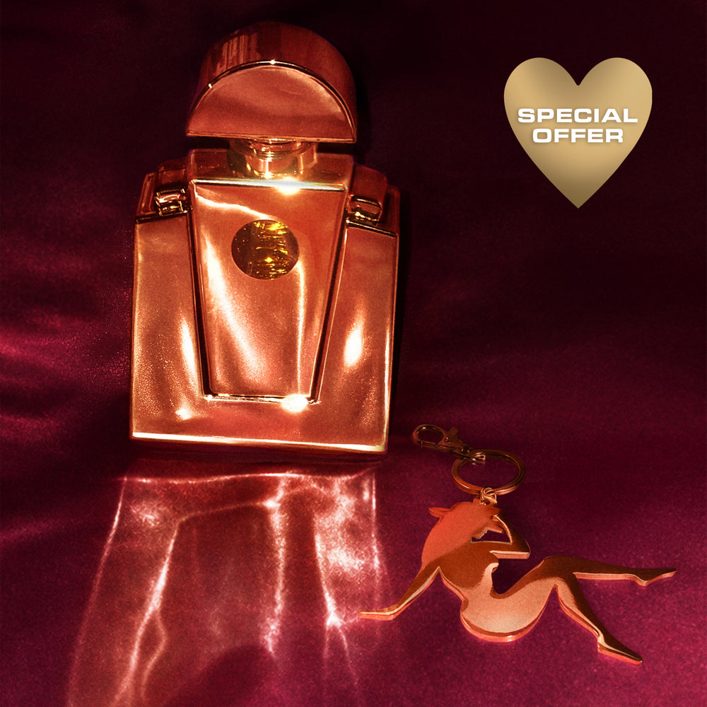 Beyoncé Cé Lumière perfume with gold Lady Bey charm on burgundy satin special offer display