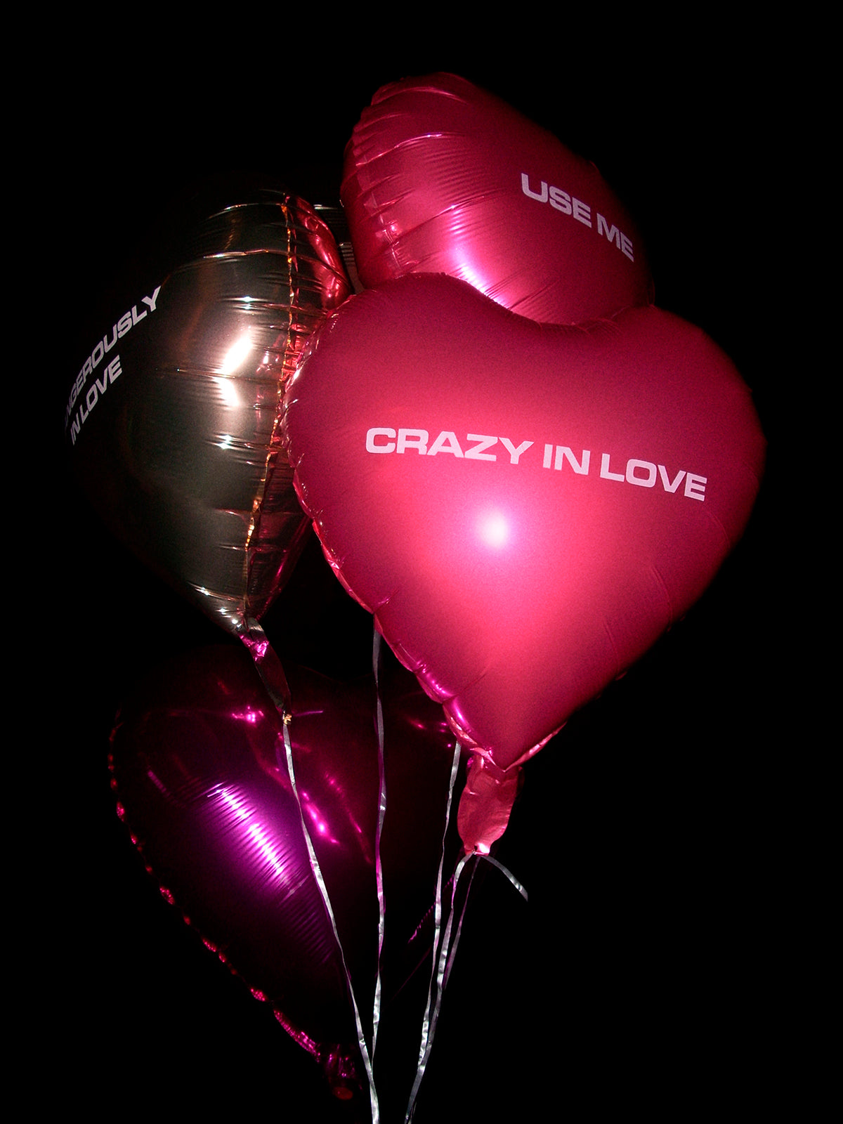 Bundle display of Beyoncé In Love heart balloons in pink, purple, and gold colors
